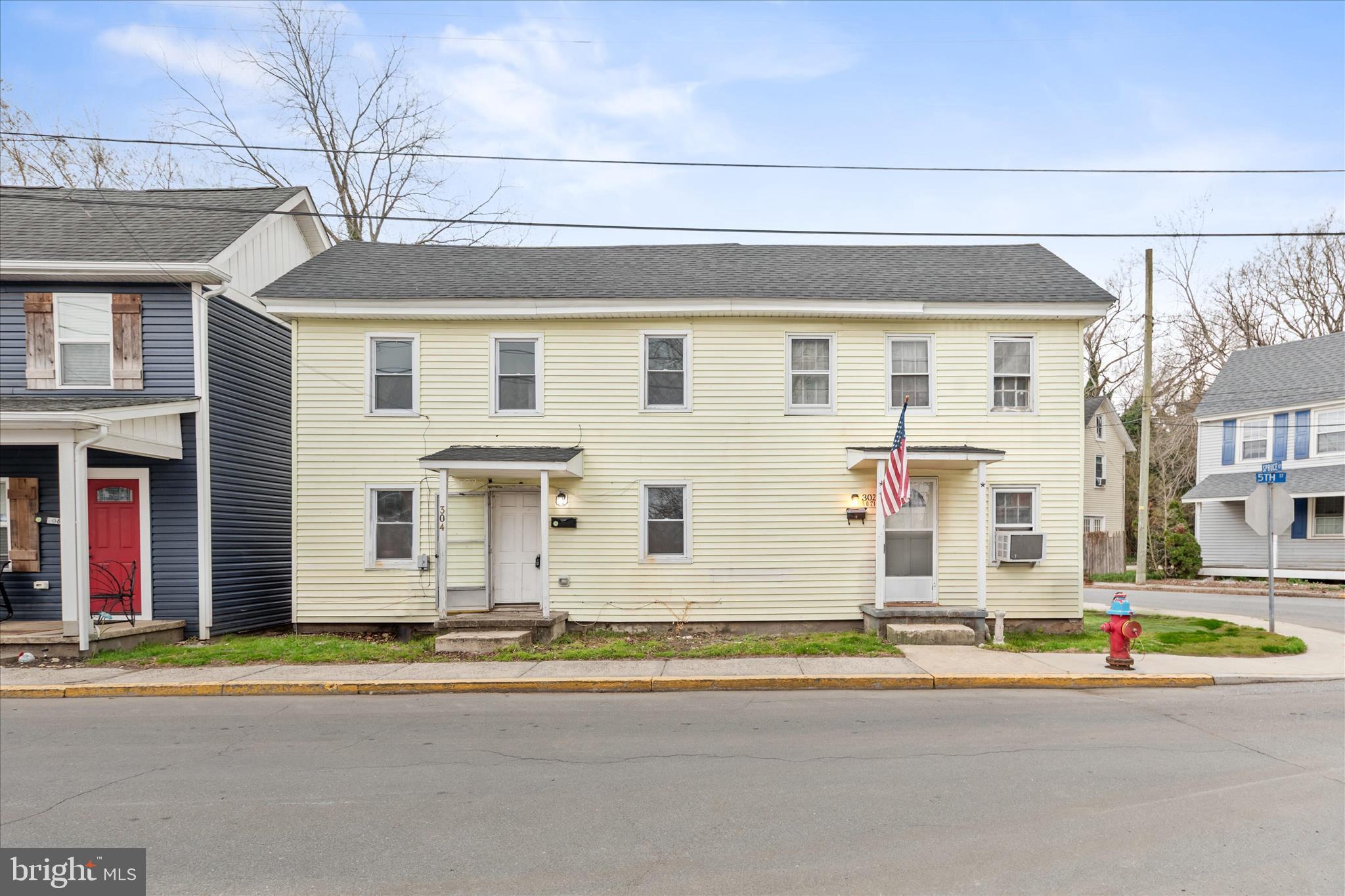a front view of a house with a road