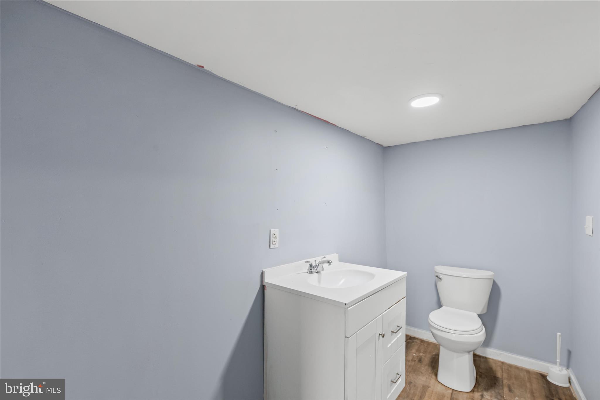 304 East 5th Street Laurel, DE 19956 - Photo 14 of 30 a bathroom with a toilet sink and mirror