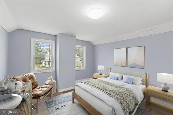 a bedroom with a bed and windows