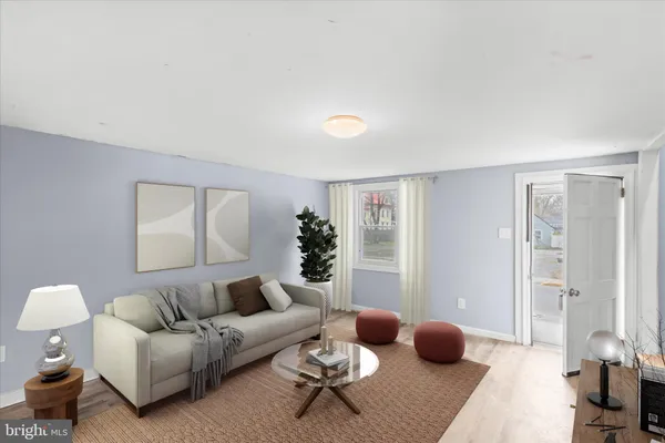 a living room with furniture a rug and a window