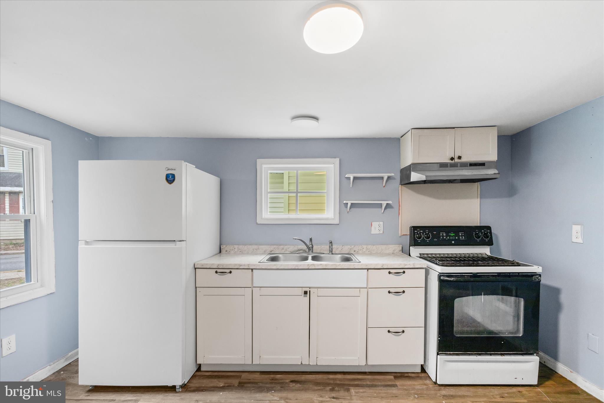 304 East 5th Street Laurel, DE 19956 - Photo 8 of 30 a kitchen with a stove cabinets and a refrigerator