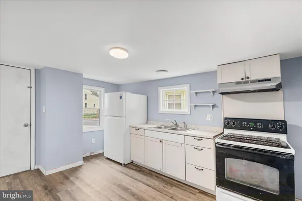 a kitchen with a stove oven and sink