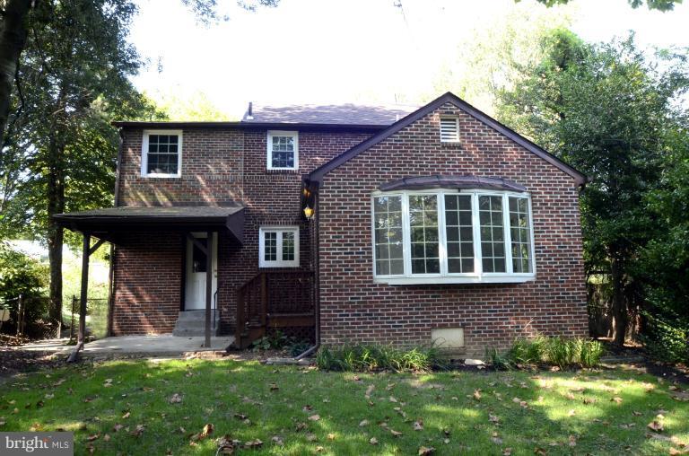 9610 Wire Avenue Silver Spring, MD 20901 - Photo 15 of 23 a front view of a house with a yard and garage