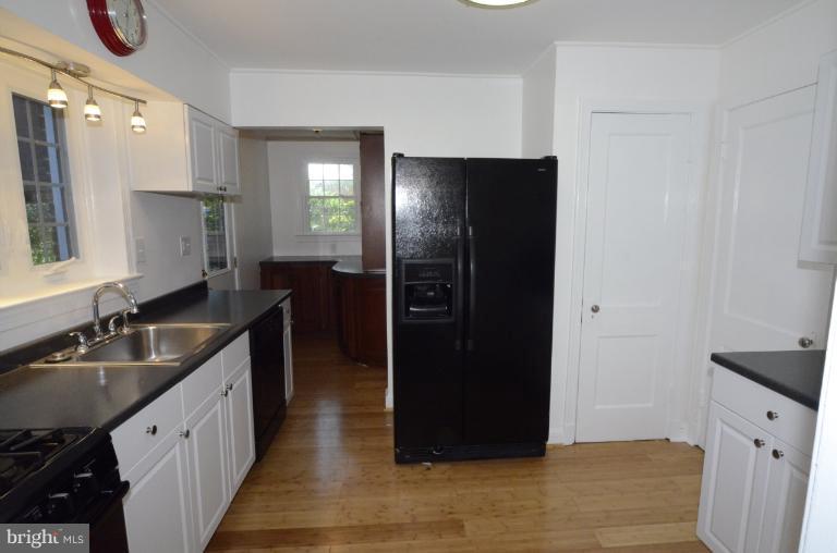 9610 Wire Avenue Silver Spring, MD 20901 - Photo 16 of 23 a kitchen with granite countertop a refrigerator and a sink