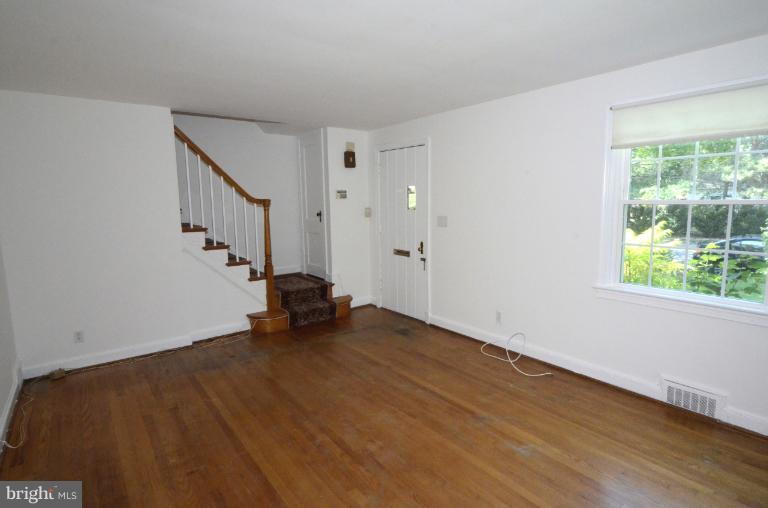 9610 Wire Avenue Silver Spring, MD 20901 - Photo 18 of 23 a view of an empty room with wooden floor and a window