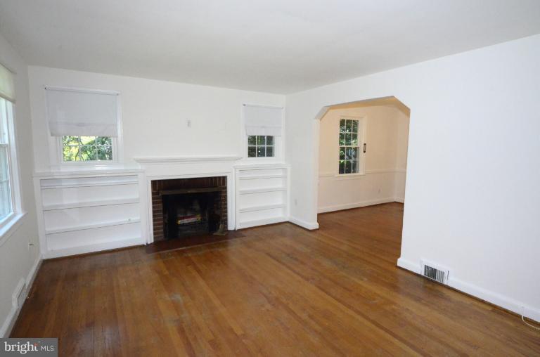 9610 Wire Avenue Silver Spring, MD 20901 - Photo 19 of 23 a view of a livingroom with wooden floor and a fireplace