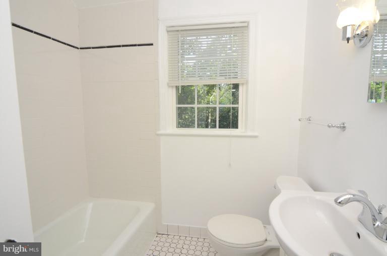 9610 Wire Avenue Silver Spring, MD 20901 - Photo 6 of 23 a white toilet sitting next to a bath tub
