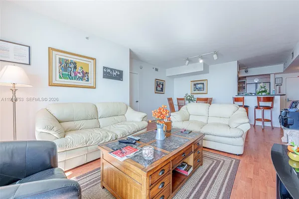 a living room with furniture and a wooden floor