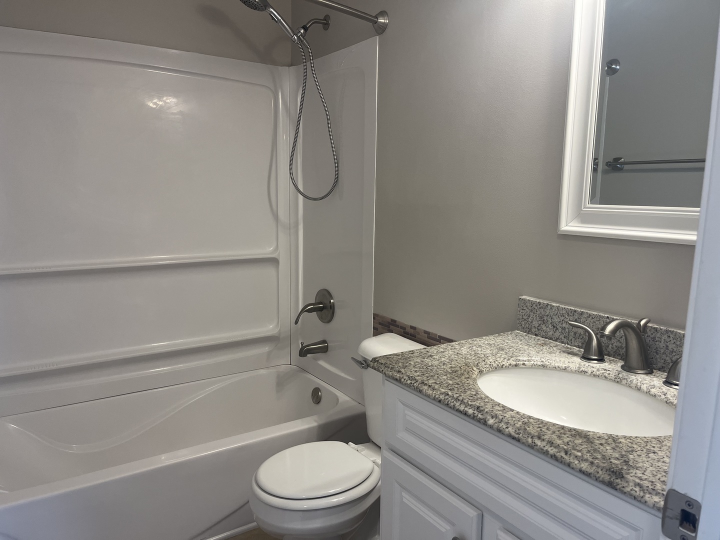2300 Light Road, Unit 201 Oswego, IL 60543 - Photo 8 of 10 a bathroom with a granite countertop sink toilet and shower