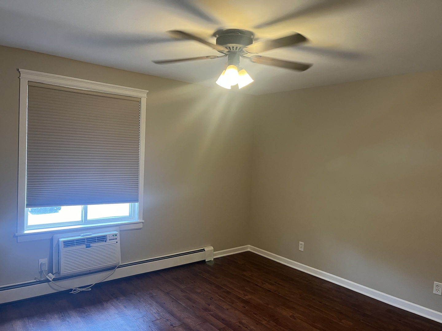 2300 Light Road, Unit 201 Oswego, IL 60543 - Photo 10 of 10 a view of an empty room with wooden floor and a window