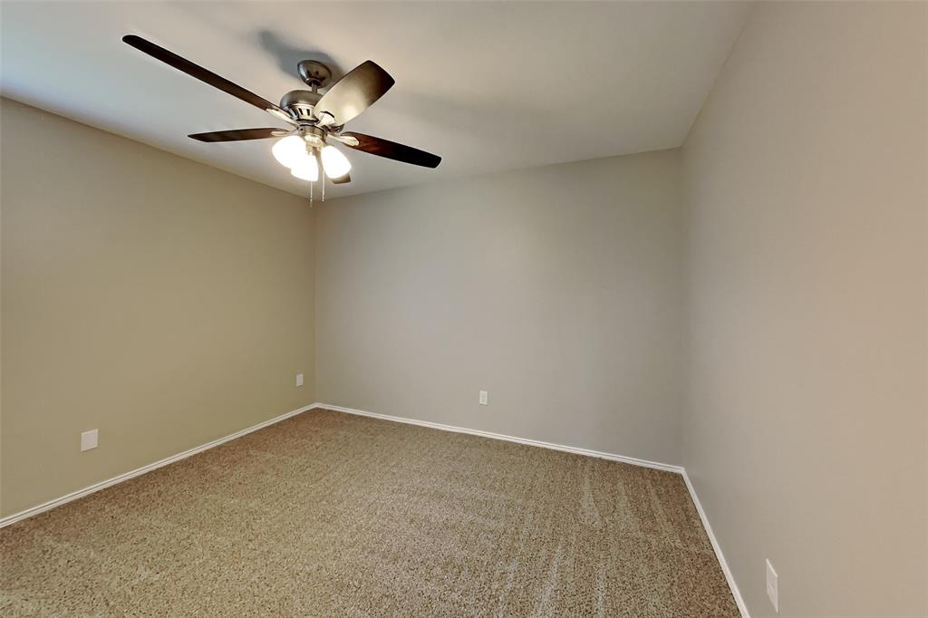 5804 Mirror Ridge Drive Fort Worth, TX 76179 - Photo 14 of 19 an empty room with a chandelier fan and a fan