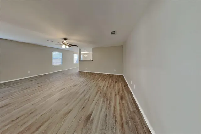 a view of wooden floor and chandelier in closet