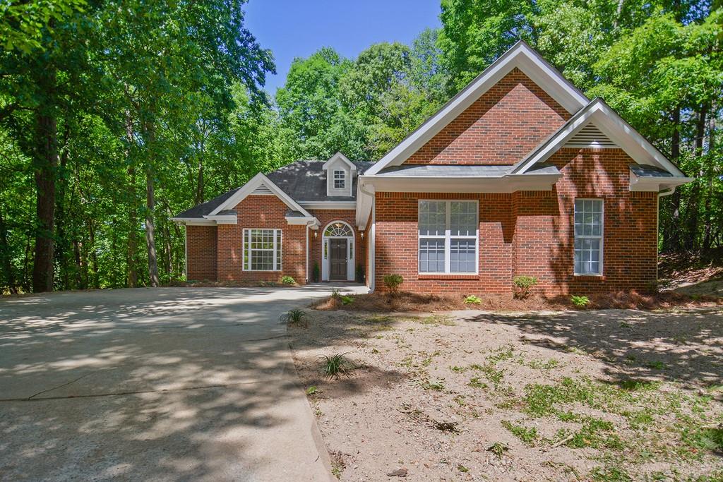 1891 County Line Road Southwest Atlanta, GA 30331 - Photo 1 of 1 a front view of a house with a yard and garage