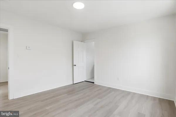 a view of an empty room and wooden floor