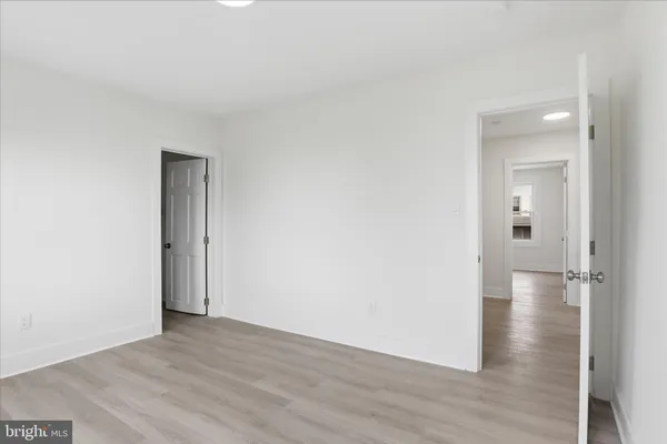 a view of a room with wooden floor
