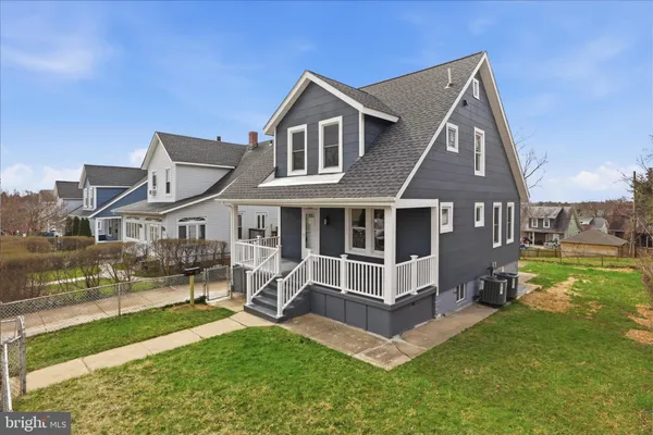 a view of a house with a yard balcony and sitting area