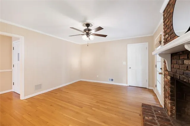 a view of an empty room with a fireplace