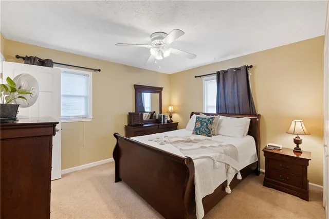 a bed room with a bed and a chandelier