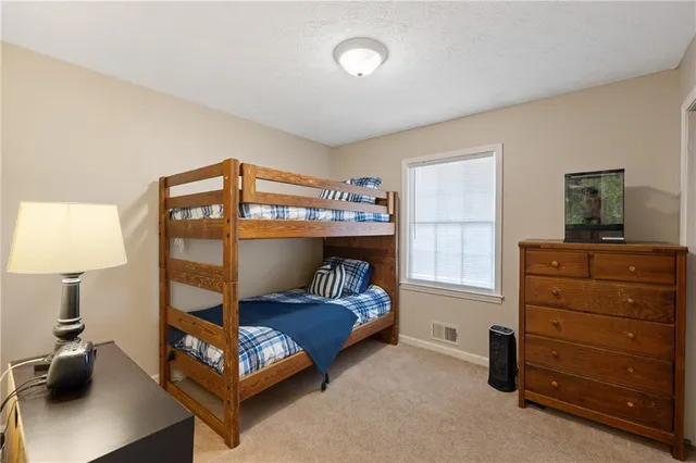 a bedroom with a bed and a tv on the dresser