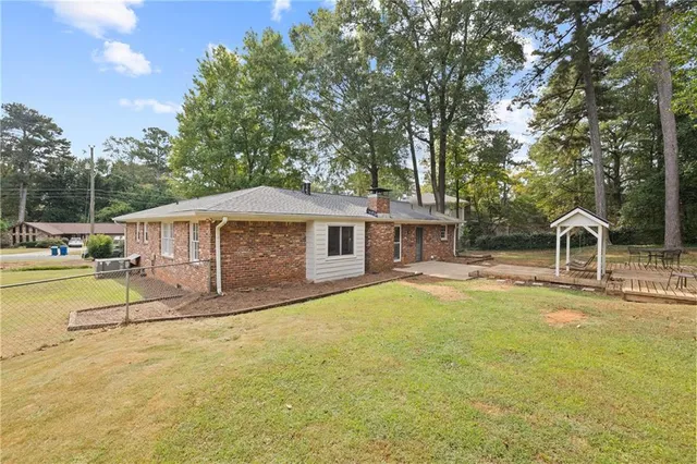 a view of a house with pool and sitting area