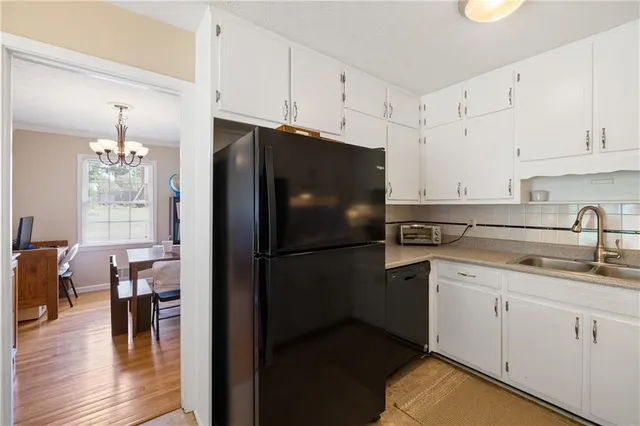 a kitchen with a refrigerator and a sink
