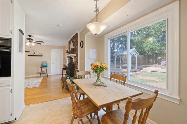 a view of a dining room with furniture large windows and wooden floor