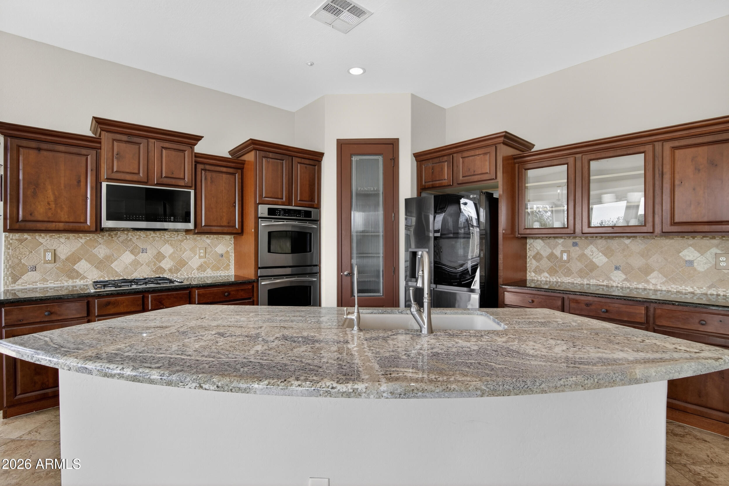 18377 Verdin Road Goodyear, AZ 85338 - Photo 10 of 55 a kitchen with stainless steel appliances granite countertop a sink and cabinets