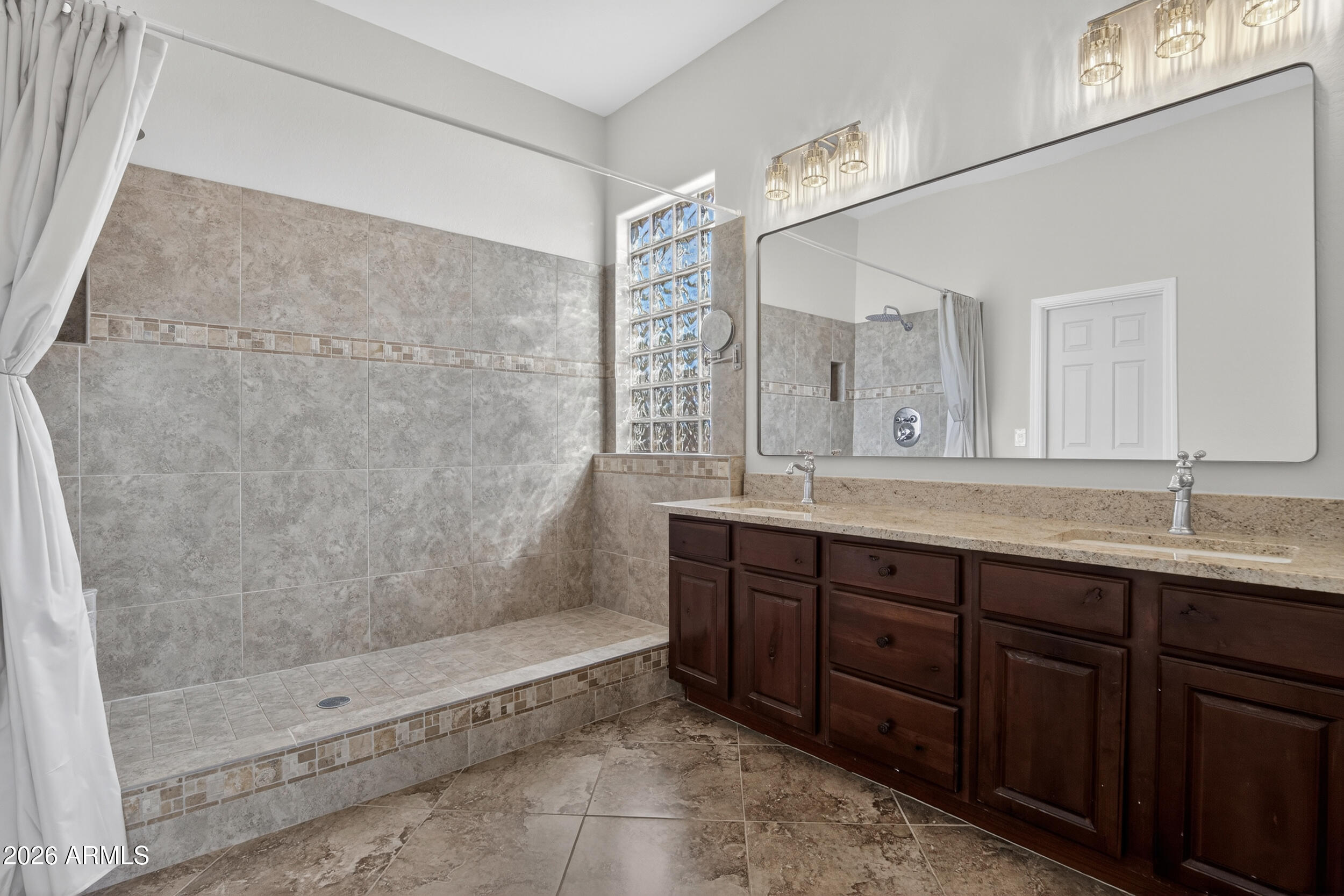18377 Verdin Road Goodyear, AZ 85338 - Photo 13 of 55 a bathroom with a granite countertop sink mirror and double
