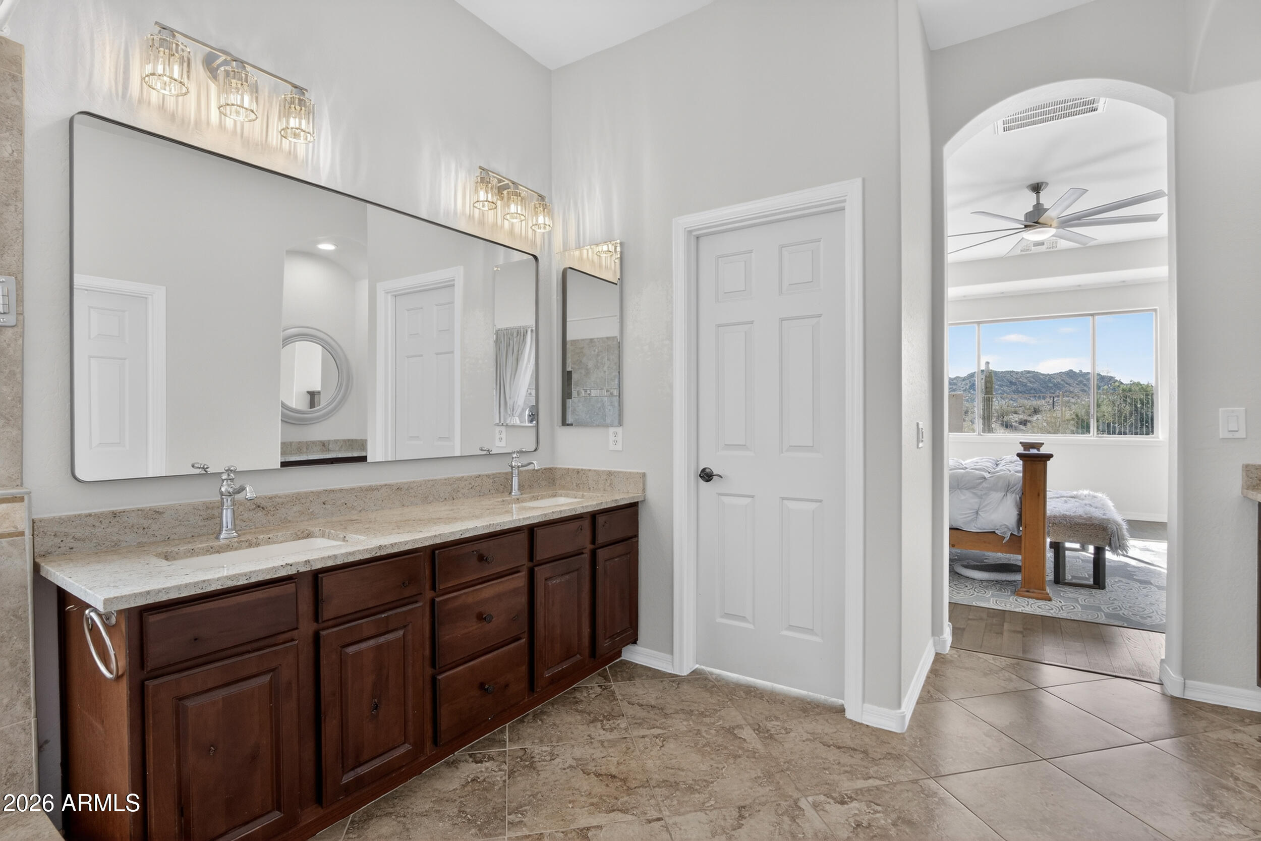 18377 Verdin Road Goodyear, AZ 85338 - Photo 14 of 55 a en suite bathroom with a granite countertop sink mirror and
