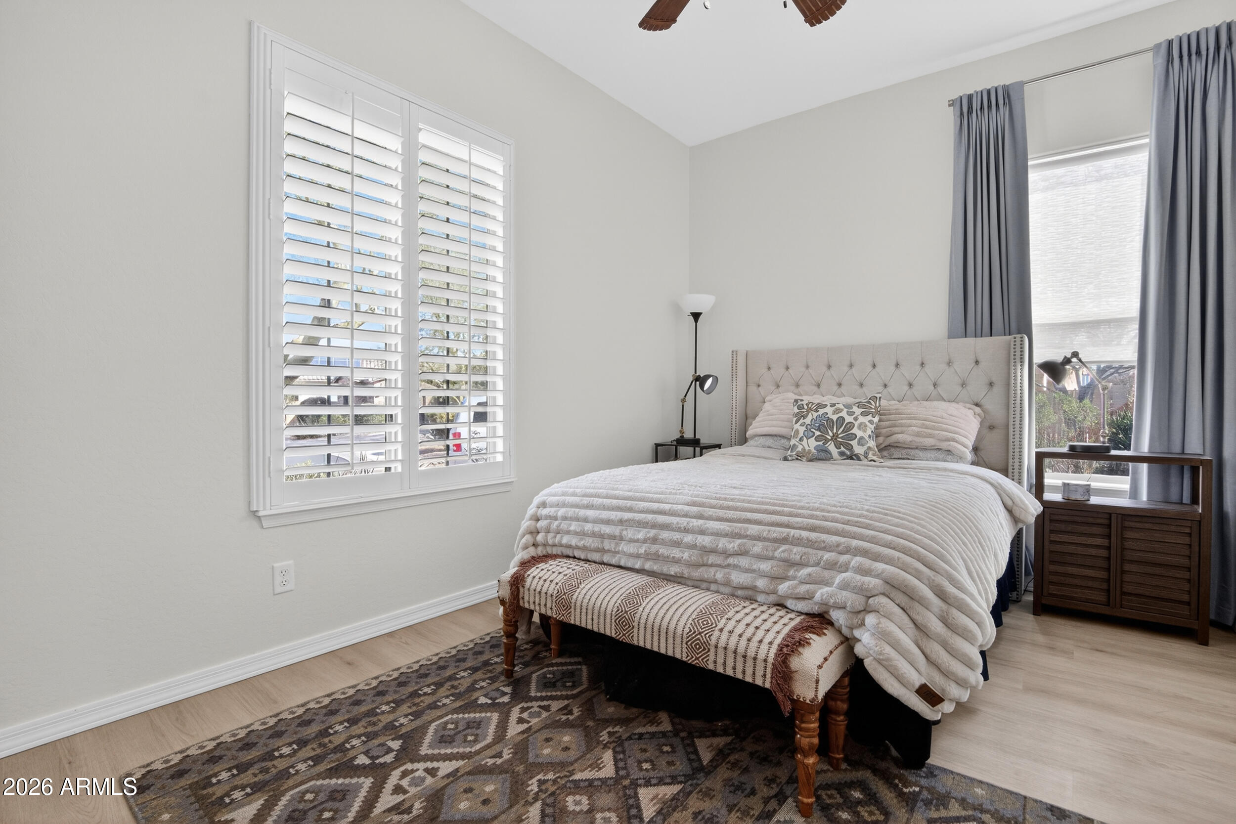 18377 Verdin Road Goodyear, AZ 85338 - Photo 15 of 55 a bedroom with a bed a window and walk in closet