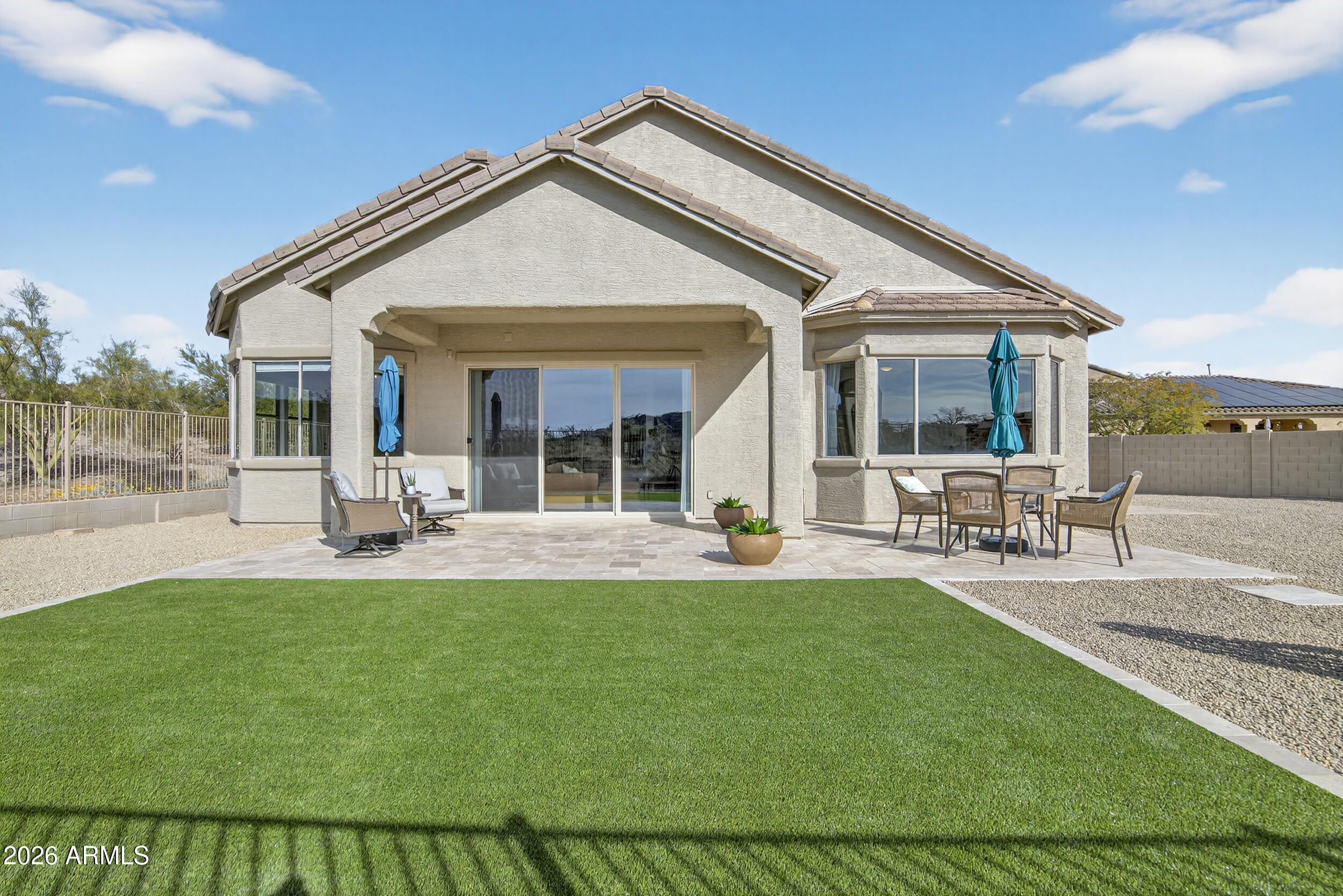 18377 Verdin Road Goodyear, AZ 85338 - Photo 27 of 55 a front view of house with patio and outdoor seating