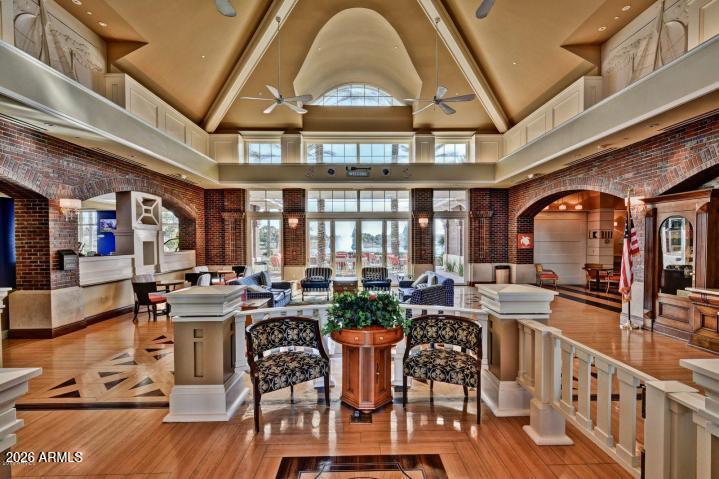 18377 Verdin Road Goodyear, AZ 85338 - Photo 52 of 55 a living room with furniture a fireplace and large windows
