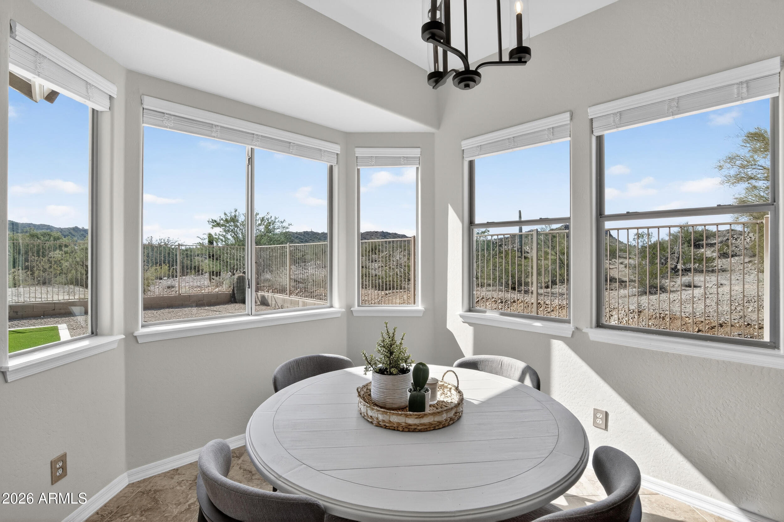 18377 Verdin Road Goodyear, AZ 85338 - Photo 7 of 55 a dining room with furniture large windows and wooden floor