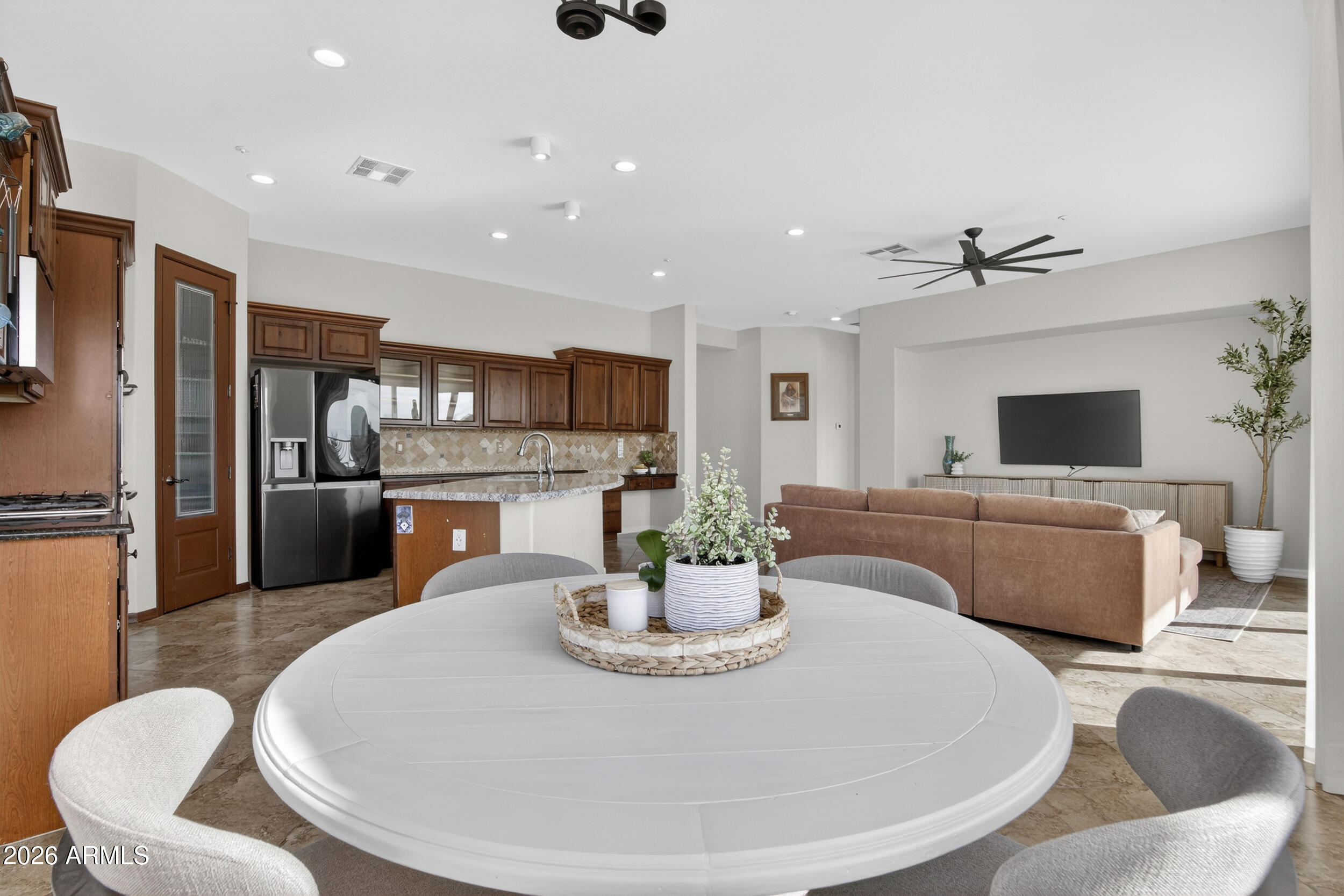 18377 Verdin Road Goodyear, AZ 85338 - Photo 9 of 55 a living room with fireplace furniture and a dining table