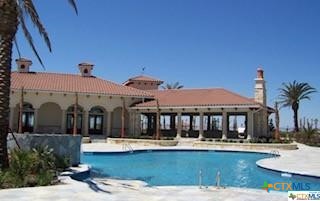 433 East Arbor Vista Port O'Connor, TX 77982 - Photo 7 of 7 a view of a white house with swimming pool table and chairs