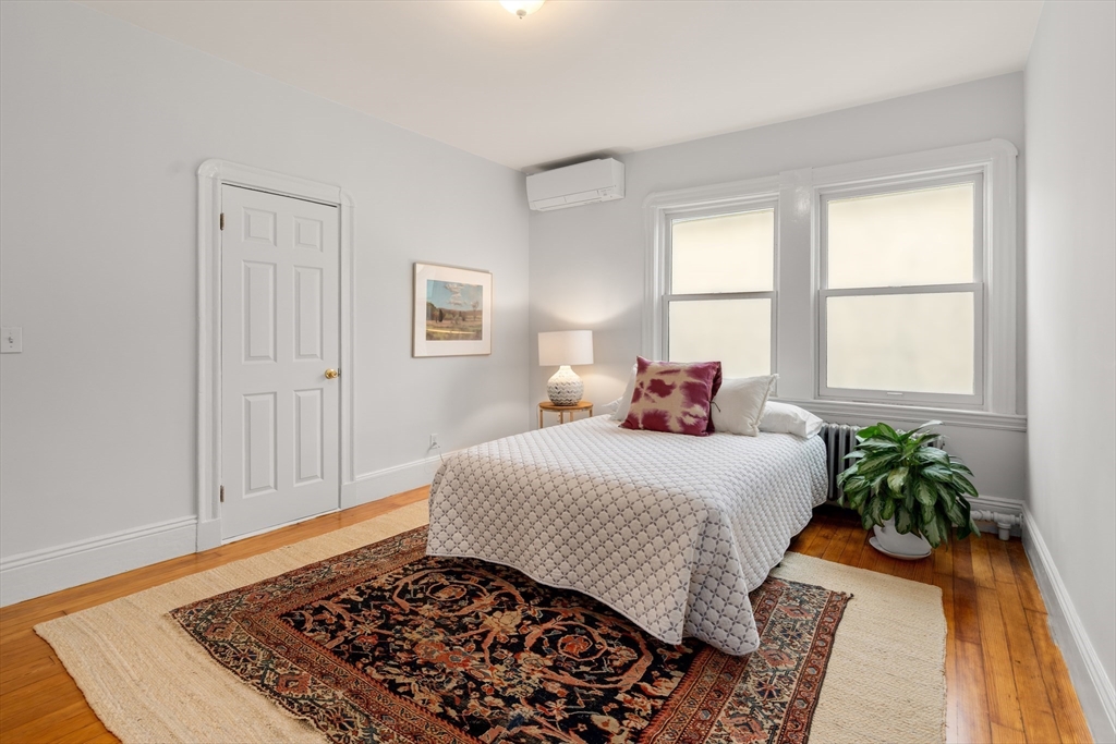 206 Pearl Street, Unit 3 Somerville, MA 02145 - Photo 12 of 18 a bedroom with a bed and wooden floor