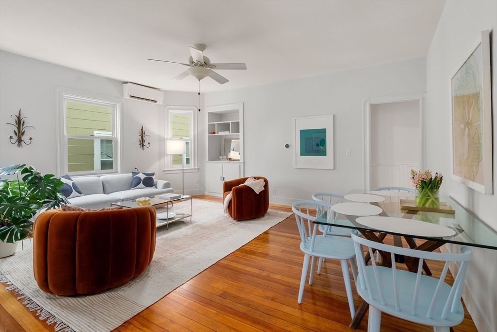 206 Pearl Street, Unit 3 Somerville, MA 02145 - Photo 2 of 18 a living room with furniture a dining table and a potted plant