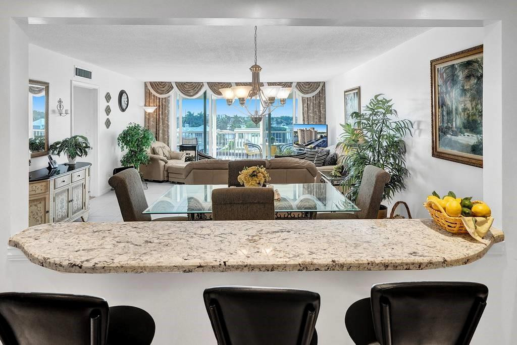 a kitchen with granite countertop kitchen island with furniture and appliances