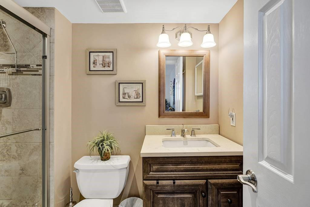 303 North Riverside Drive, Unit 503 Pompano Beach, FL 33062 - Photo 13 of 29 a bathroom with a toilet sink and mirror