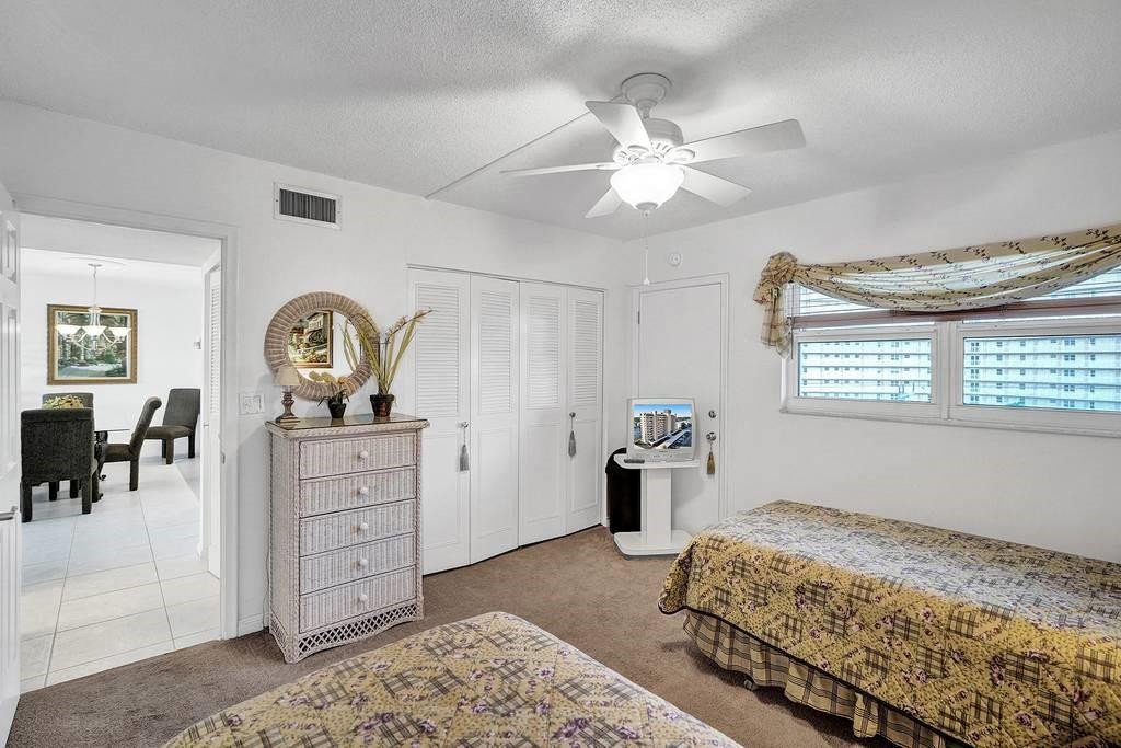 303 North Riverside Drive, Unit 503 Pompano Beach, FL 33062 - Photo 17 of 29 a bedroom with a bed and ceiling fan