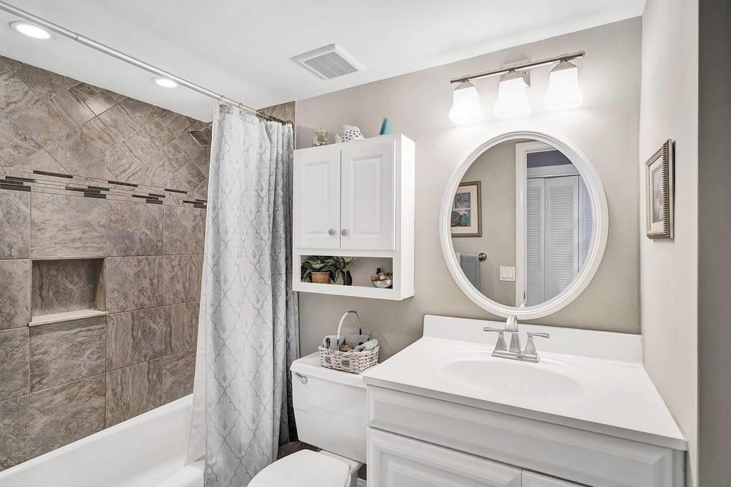 303 North Riverside Drive, Unit 503 Pompano Beach, FL 33062 - Photo 18 of 29 a bathroom with a sink a mirror a toilet and a mirror