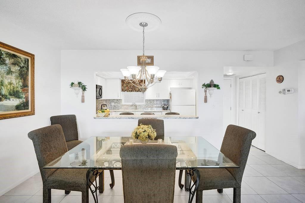 303 North Riverside Drive, Unit 503 Pompano Beach, FL 33062 - Photo 5 of 29 a view of a dining room with furniture and wooden floor