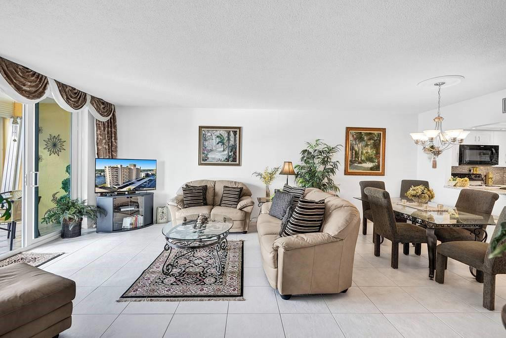 303 North Riverside Drive, Unit 503 Pompano Beach, FL 33062 - Photo 6 of 29 a living room with furniture and a fireplace with wooden floor