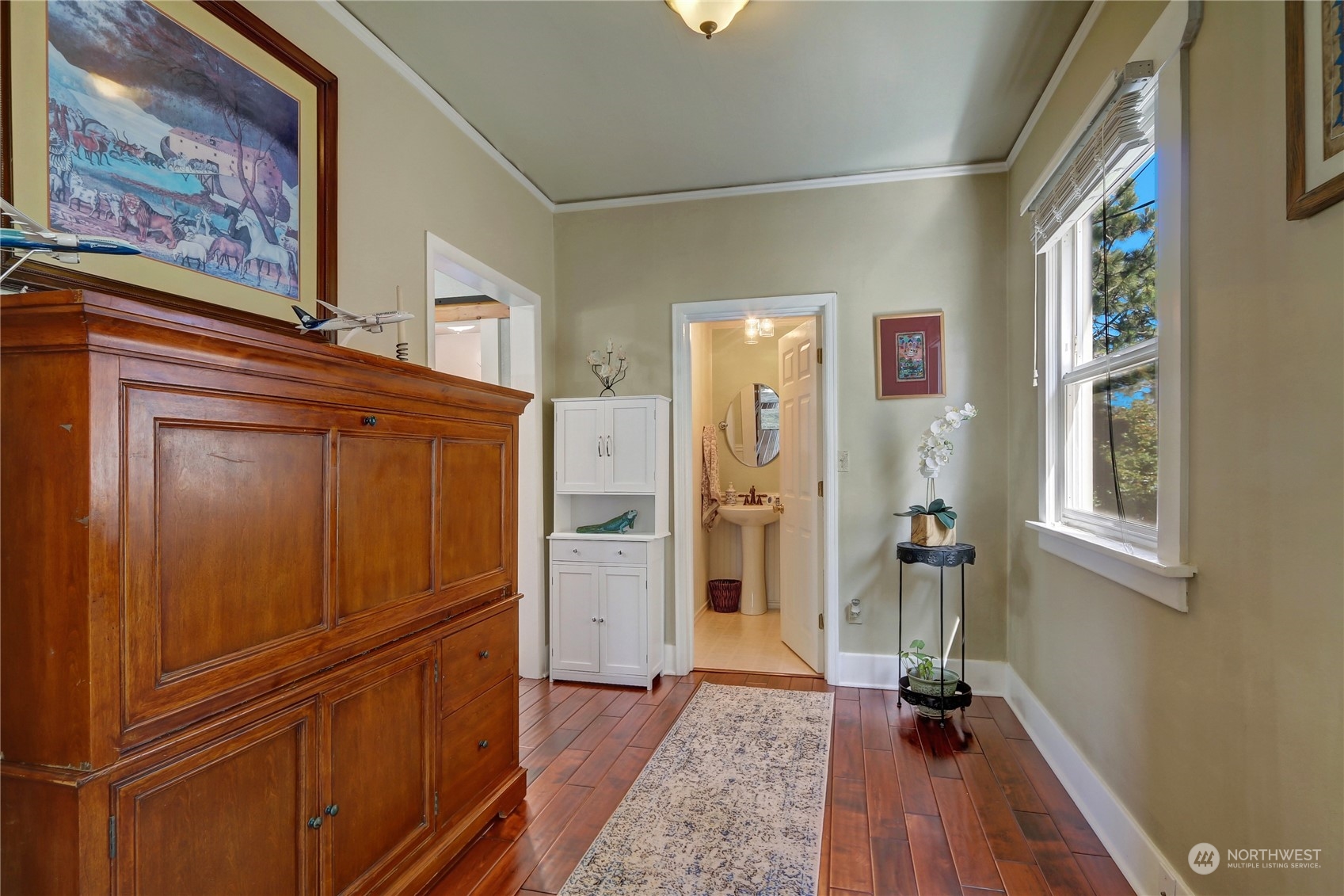 2203 Rockefeller Avenue Everett, WA 98201 - Photo 11 of 31 a view of walk in closet with window and wooden floor