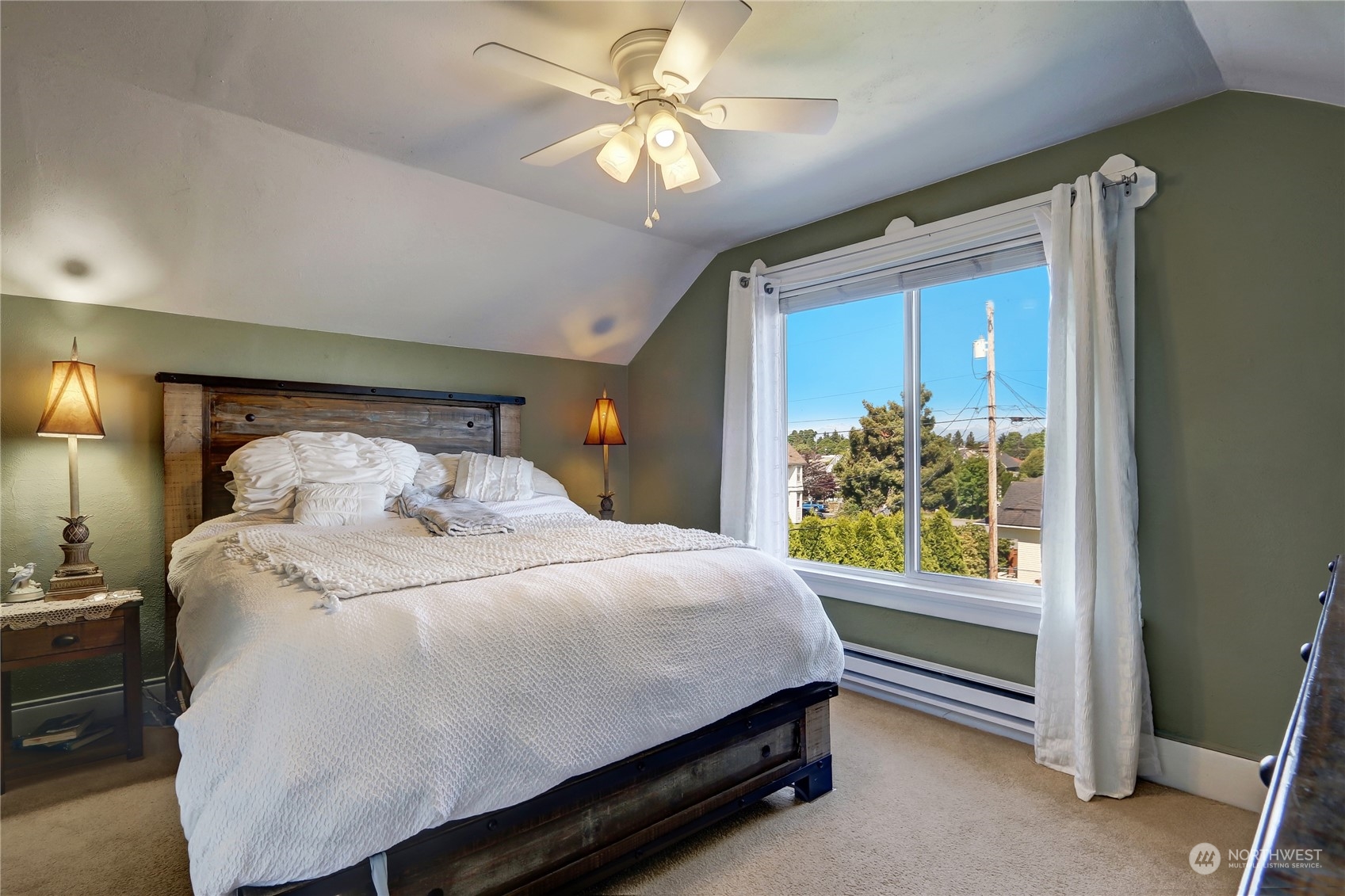 2203 Rockefeller Avenue Everett, WA 98201 - Photo 22 of 31 a bedroom with a bed and a chandelier