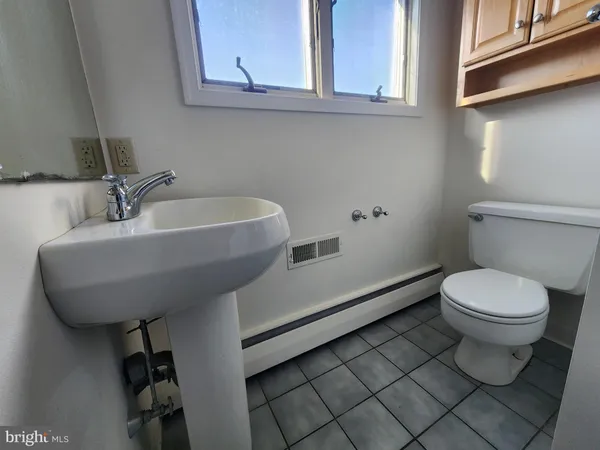 a view of empty room with window and wooden floor