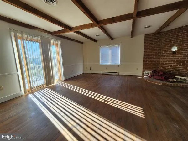 a view of a room with wooden floor