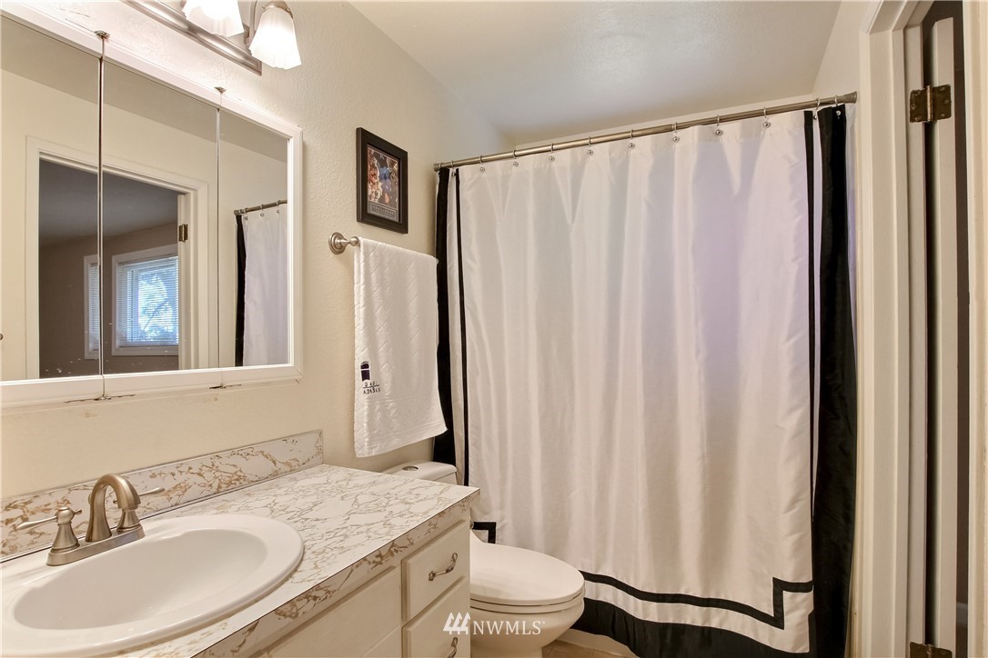 509 223rd Street Southwest Bothell, WA 98021 - Photo 17 of 39 a bathroom with a granite countertop sink and a mirror