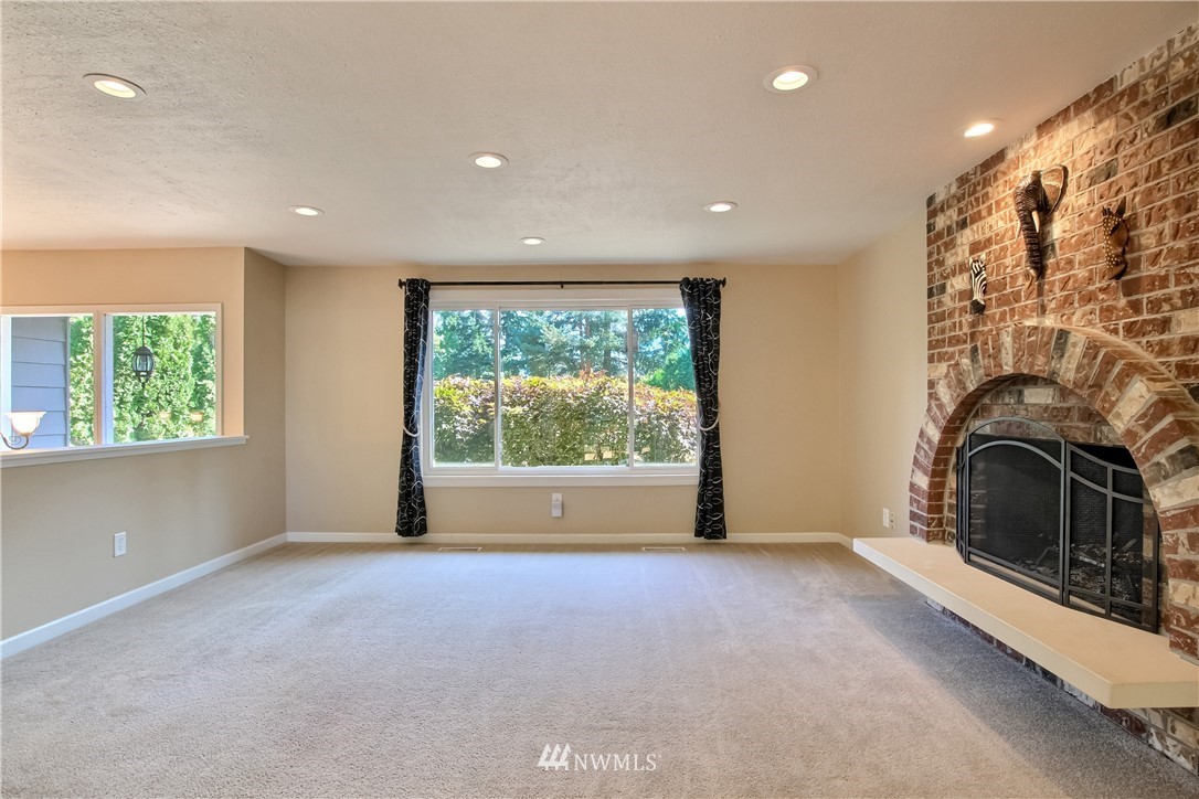 509 223rd Street Southwest Bothell, WA 98021 - Photo 5 of 39 a view of empty room with fireplace and fan