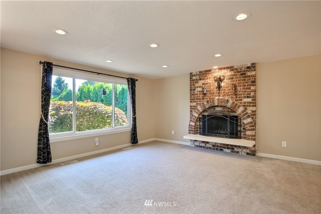 509 223rd Street Southwest Bothell, WA 98021 - Photo 8 of 39 an empty room with fireplace and a window